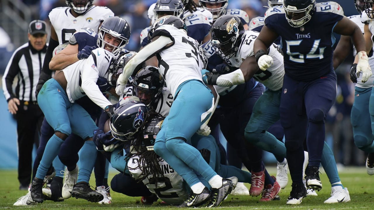 Jacksonville Jaguars linebacker Travon Walker (44) tackles Tennessee Titans  running back Derrick Henry in the second half of an NFL football game,  Saturday, Jan. 7, 2023, in Jacksonville, Fla. (AP Photo/John Raoux