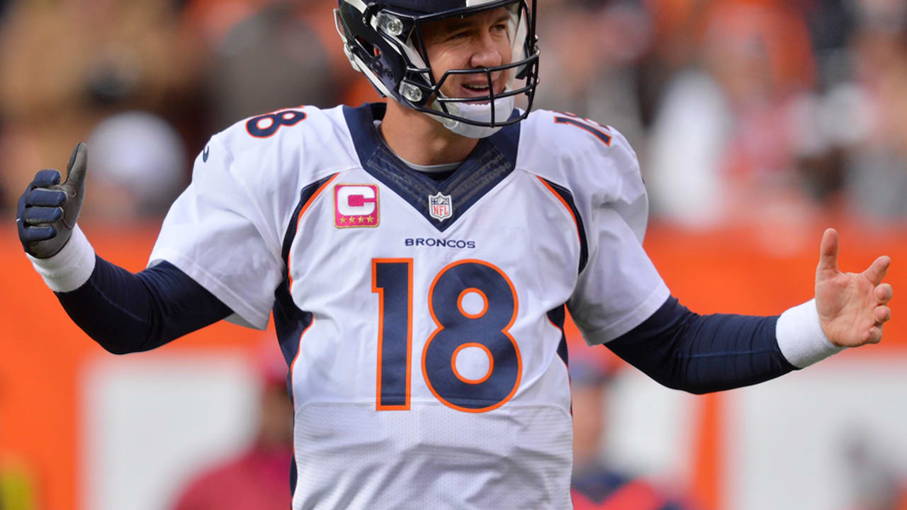 Denver Broncos quarterback Peyton Manning (18) sits on the bench