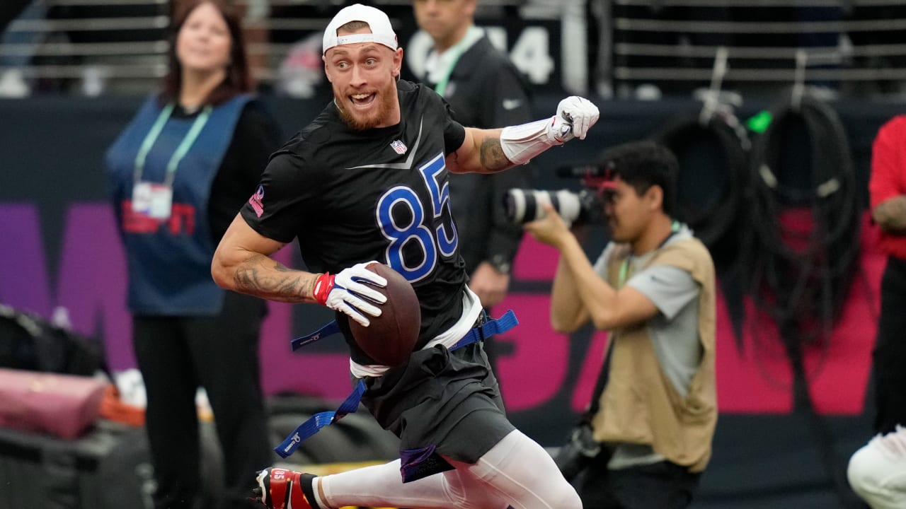 San Francisco 49ers tight end George Kittle swipes past two AFC