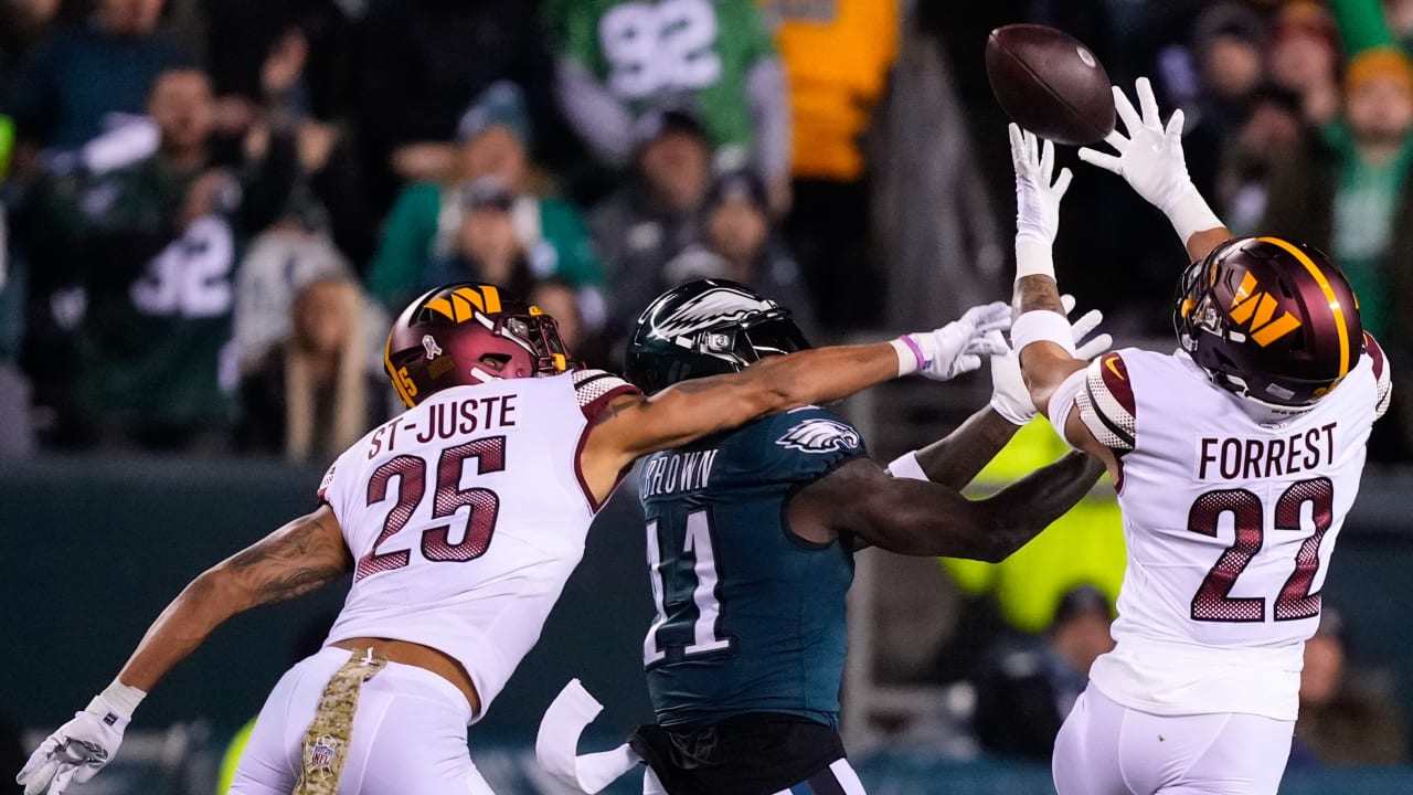 Washington Commanders defensive back Darrick Forrest intercepts