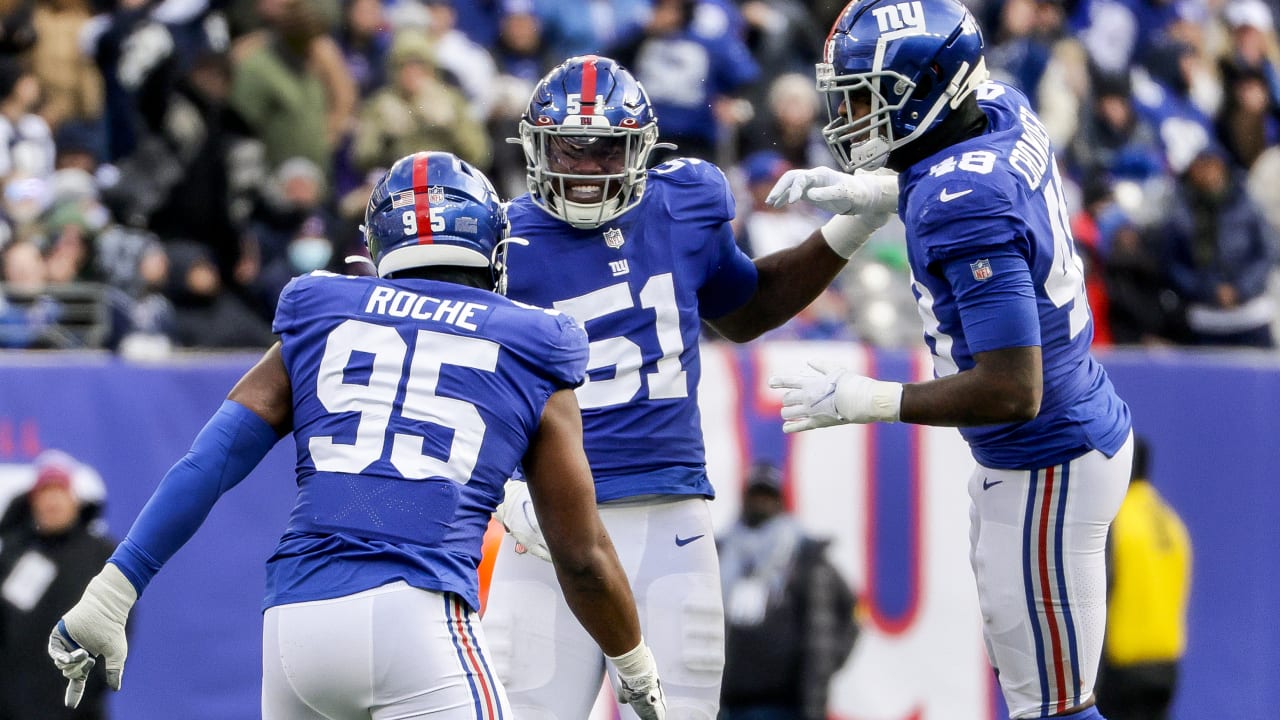 New York Giants' defenders rush the edge untouched for key sack.