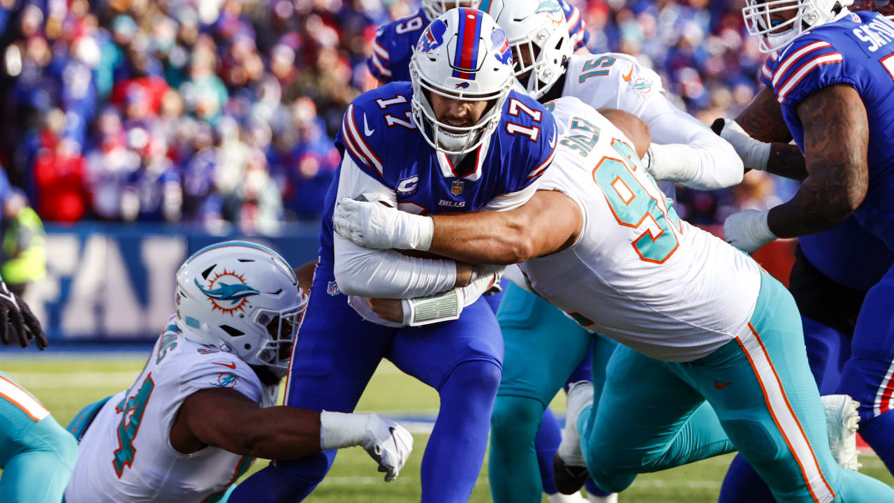 Buffalo Bills quarterback Josh Allen (17) is being sacked by Miami Dolphins  defensive tackle Zach Sieler (92) during fourth quarter of an NFL football  game at Highmark Stadium on Saturday, Dec. 17