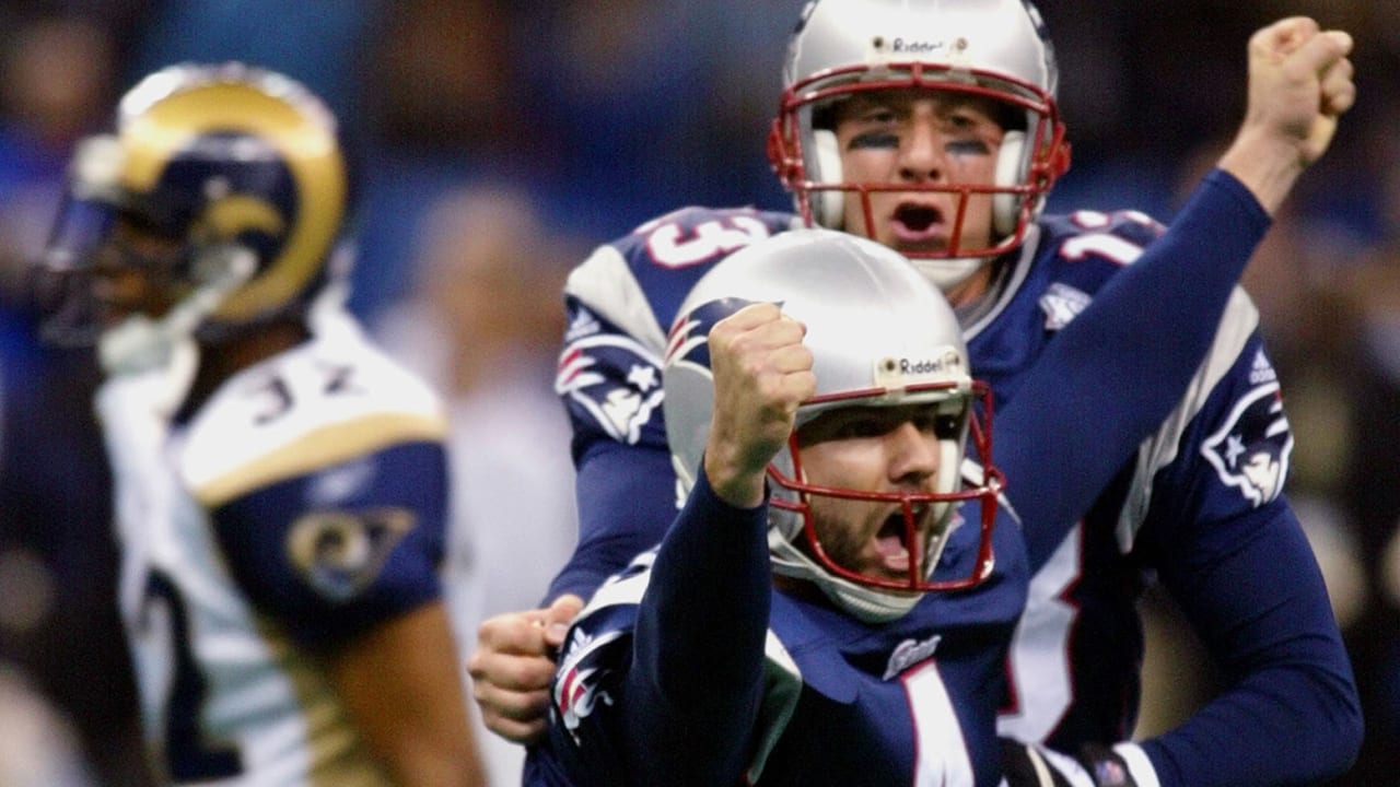 New England Patriots' cornerback Terrell Buckley (27) scoops up a St. Louis  Rams fumble in front of Patriots' Lawyer Milloy (36) and Tebucky Jones (34)  in Super Bowl XXXVI Sunday, Feb. 3