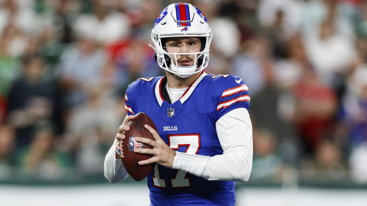 Buffalo Bills quarterback Josh Allen evades pressure for a 14-yard gain