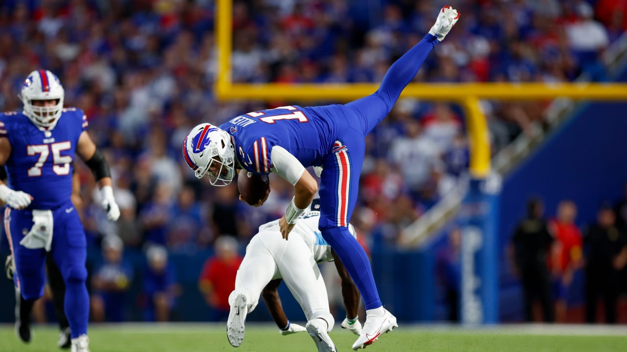 Buffalo Bills quarterback Josh Allen hurdles Tennessee Titans cornerback  Roger McCreary on scramble for first-down yardage