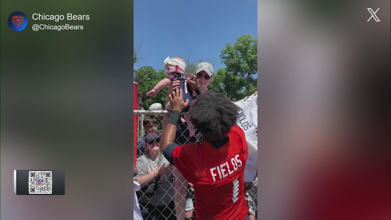 Chicago Bears quarterback Justin Fields signs baby's Bears jersey