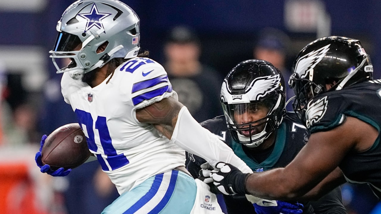 Dallas Cowboys running back Ezekiel Elliott smiles on the sideline