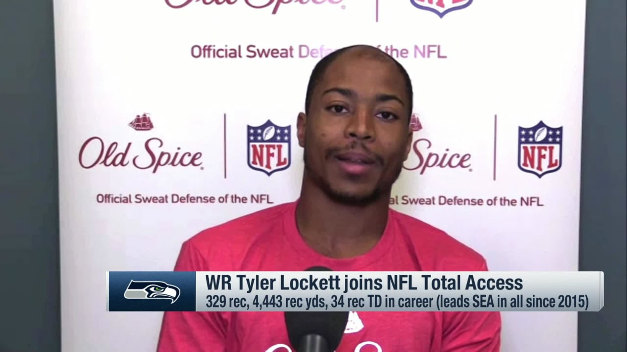 Wide receiver Tyler Lockett of the Seattle Seahawks smiles between