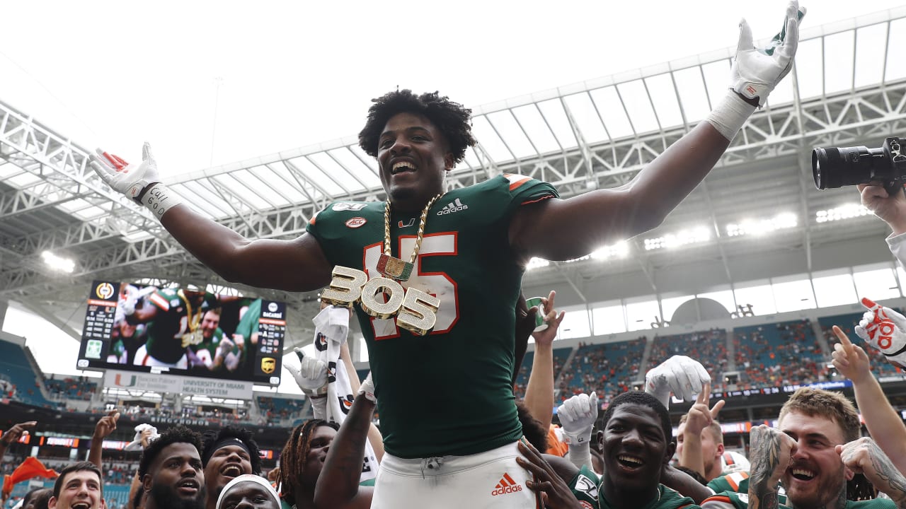 Miami edge rusher Gregory Rousseau, right, holds a team jersey