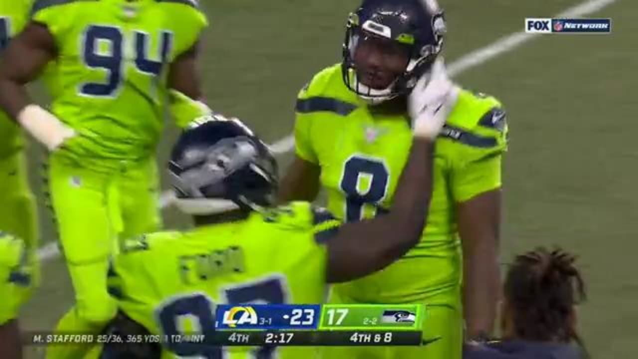 Seattle Seahawks defensive end Carlos Dunlap uses all of 6foot6 frame to swat down thirddown pass