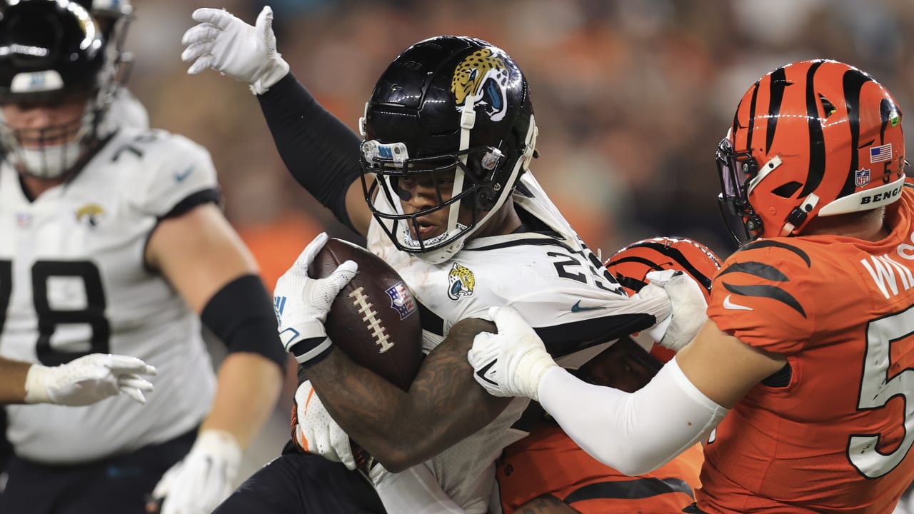 Jacksonville Jaguars' James Robinson (25) is tackled by Cincinnati Bengals'  Vonn Bell (24) during the first half of an NFL football game, Thursday,  Sept. 30, 2021, in Cincinnati. (AP Photo/Michael Conroy Stock Photo - Alamy