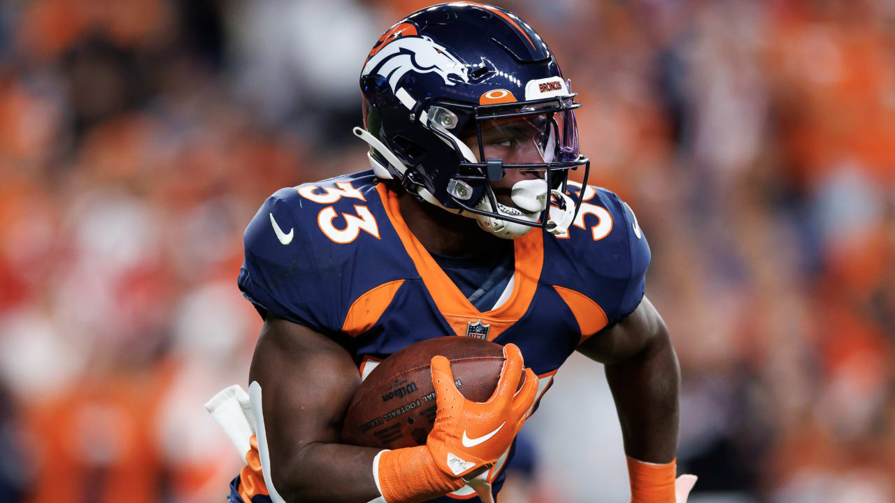 Running back Javonte Williams of the Denver Broncos runs with the
