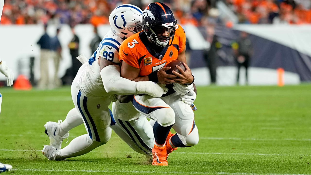 Denver Broncos quarterback Russell Wilson (3) is tackled by Indianapolis  Colts defensive tackle DeForest Buckner (99)