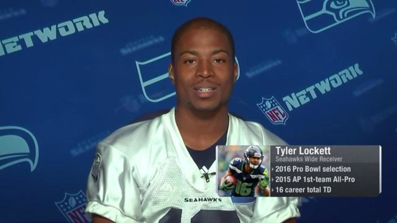 Wide receiver Tyler Lockett of the Seattle Seahawks smiles between