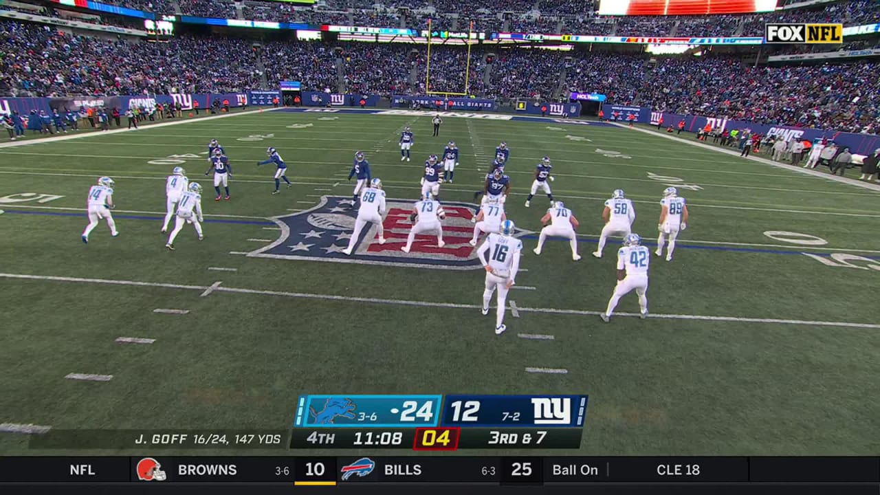 Detroit Lions quarterback Jared Goff's rollout pass hits wide receiver Amon St. Brown in stride