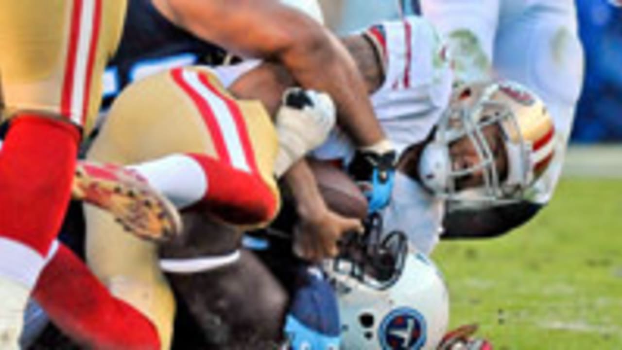 San Francisco 49ERS Colin Kaepernick breaks a tackle from New York