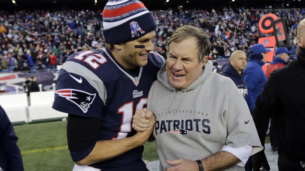 New England Patriots Tom Brady and head coach Bill Belichick smile on the  field during practice before the game against the New York Giants at Giants  Stadium in East Rutherford, New Jersey