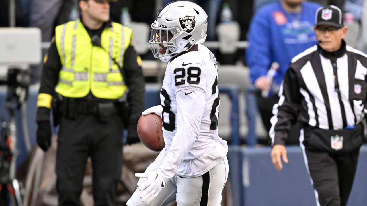 Las Vegas Raiders running back Josh Jacobs (28) stiff arms New York Giants  cornerback James Bra …