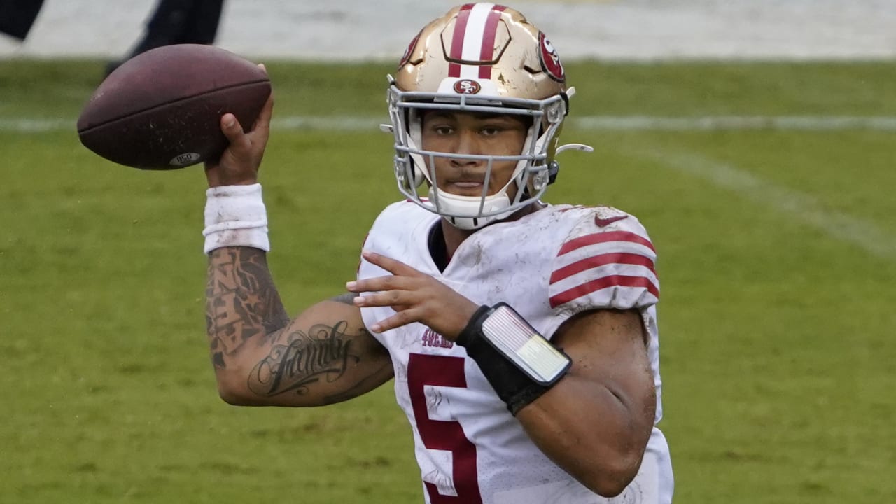 Quarterback Trey Lance of the San Francisco 49ers escapes a sack