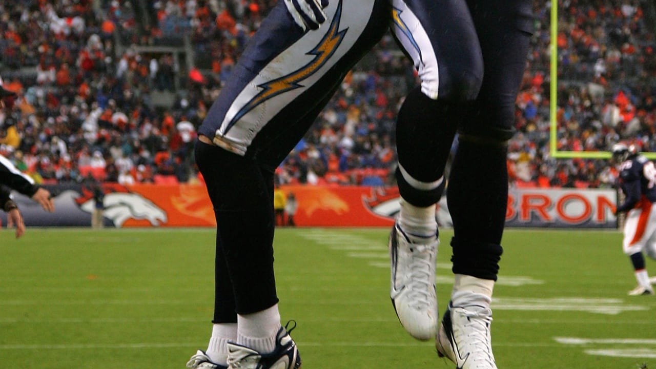 New York Jets running back LaDainian Tomlinson (21) celebrates his game-winning  two-yard touchdown run with Denver Broncos cornerback Nate Jones watching  in the fourth quarter at Invesco Field at Mile High on