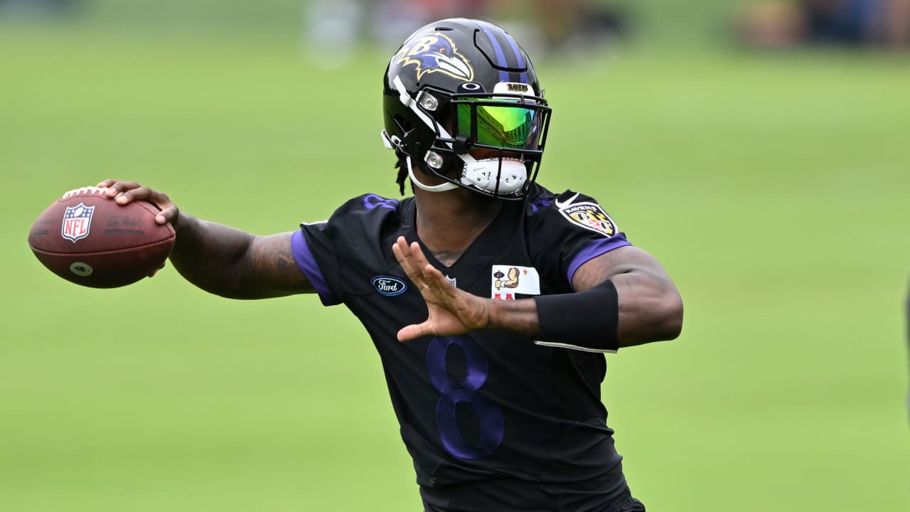 Baltimore Ravens quarterback Lamar Jackson (8) takes to the field with a  member of the military as part of Salute to Service before an NFL football  game against the Carolina Panthers, Sunday