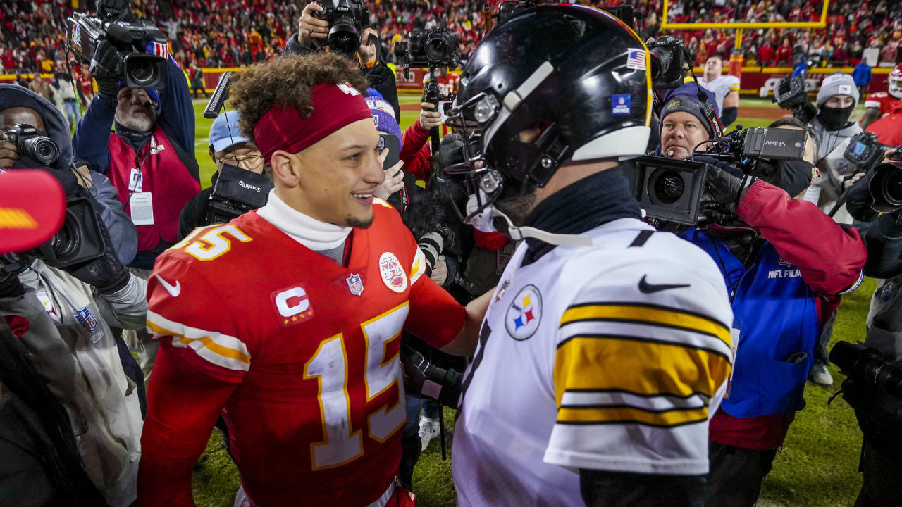 Fans cheer as teams warm up before an NFL wild-card football game