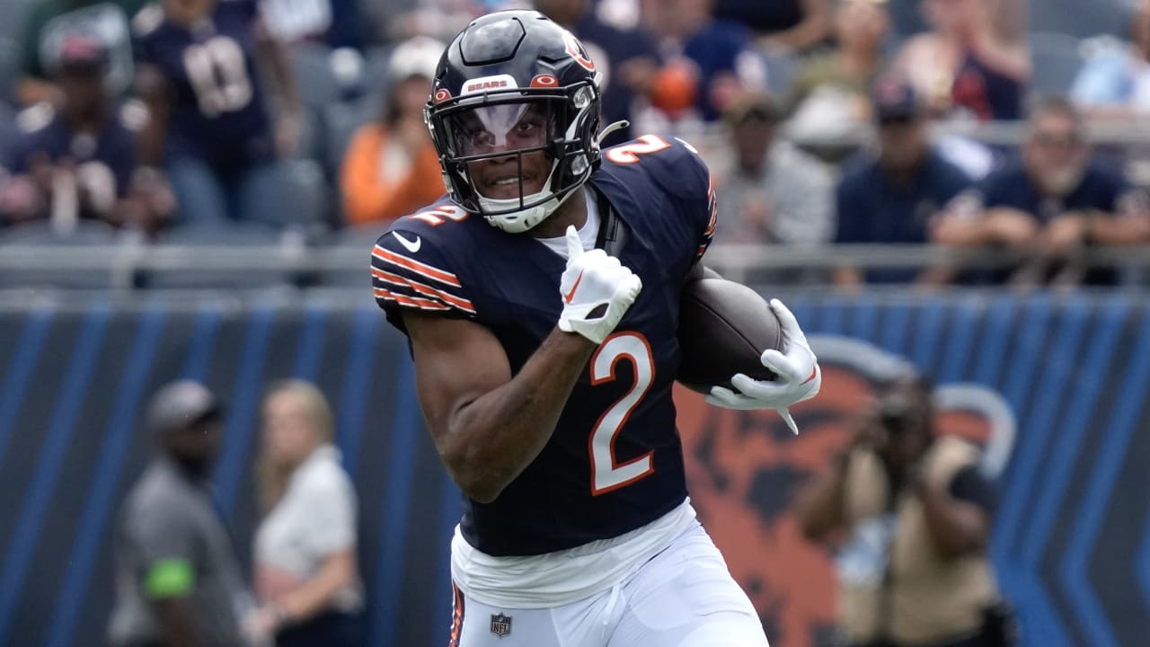 Chicago Bears wide receiver DJ Moore slips through tackles en route to