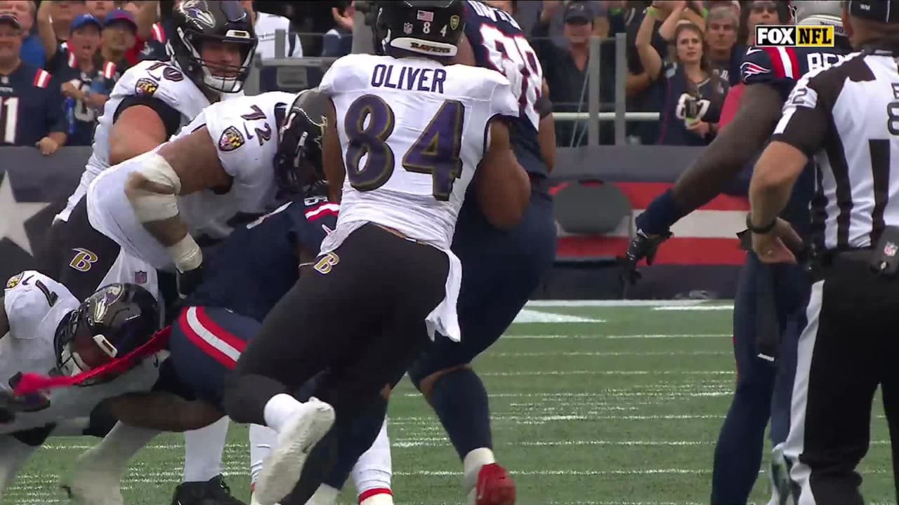 New England Patriots cornerback Jonathan Jones rips out the football from  Baltimore Ravens wide receiver Rashod Bateman to force turnover