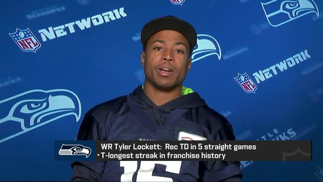 Wide receiver Tyler Lockett of the Seattle Seahawks smiles between