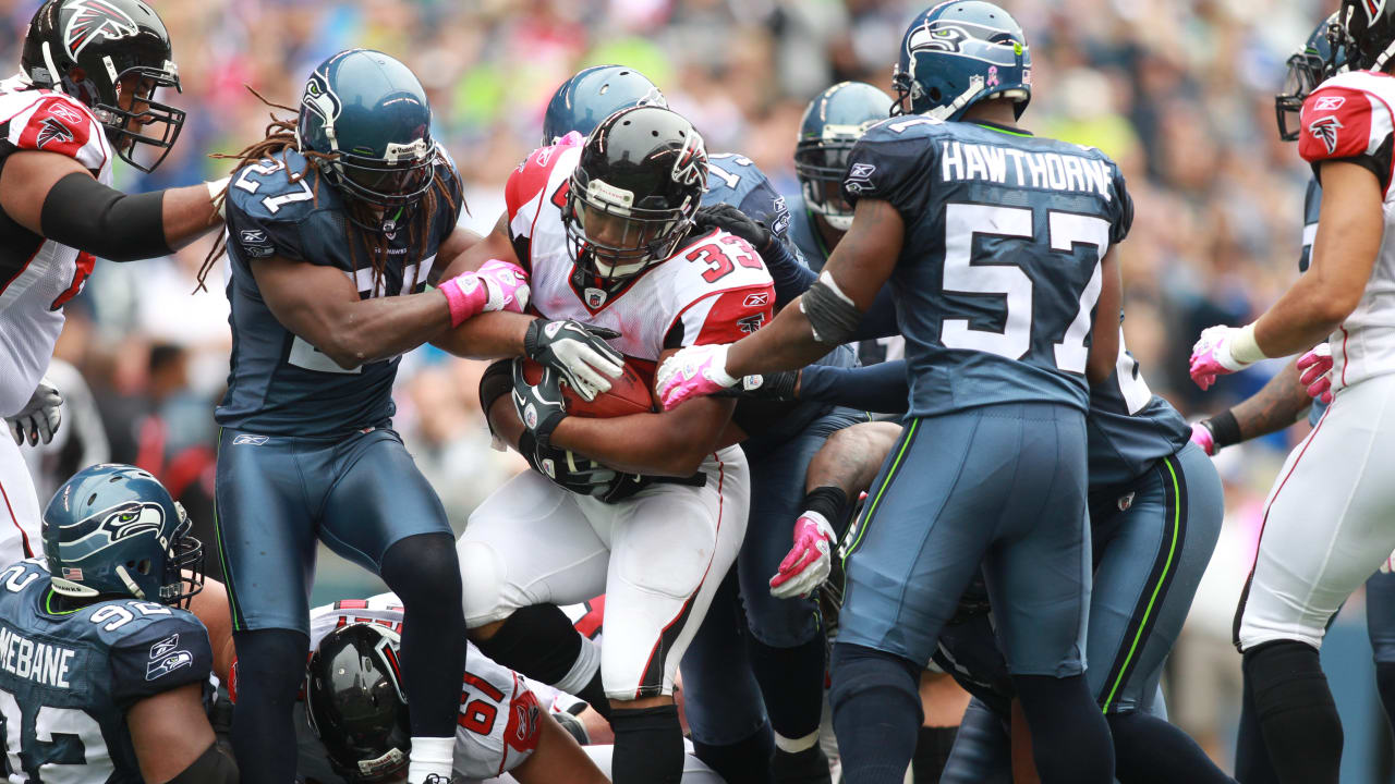 Atlanta Falcons tight end Alge Crumpler (83) is upended by Seattle Seahawks'  Marcus Trufant after a catch for short yardage in the third quarter of an  NFL football game Sunday , Dec.