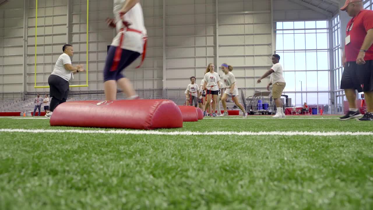 Julia Crossley delivers game ball to referee Carl Cheffers as part of NFL  PLAY 60