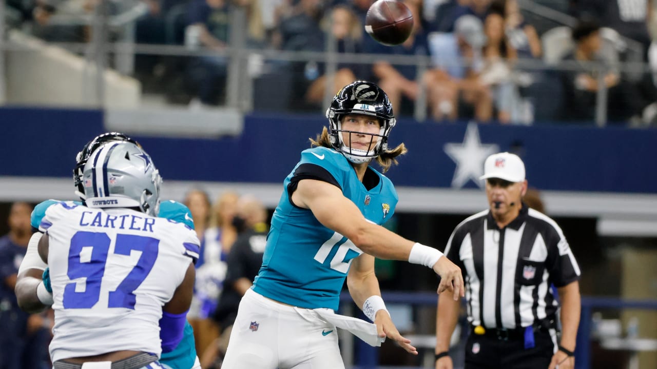 Jacksonville Jaguars quarterback Trevor Lawrence takes notes as he watches  play against the Dallas Cowboys in the second half of a preseason NFL  football game in Arlington, Texas, Sunday, Aug. 29, 2021. (