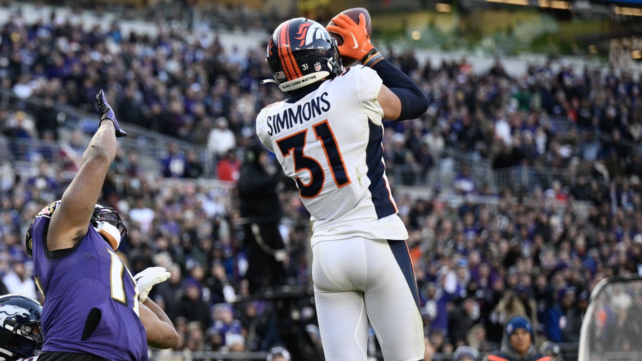 Justin Simmons of the Denver Broncos signals for fourth down