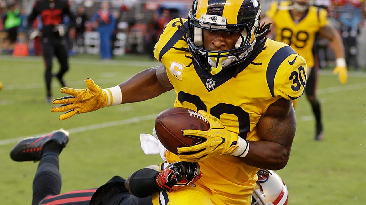 Los Angeles Rams running back Todd Gurley (30) runs for a touchdown against San  Francisco 49ers defensive back Dontae Johnson (36) during the first half of  an NFL football game in Santa