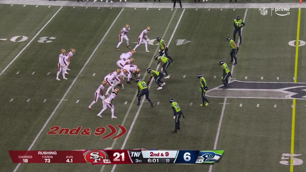 San Francisco 49ers quarterback Brock Purdy runs against Seattle Seahawks  defensive tackle Quinton Jefferson during the second half of an NFL  football game in Seattle, Thursday, Dec. 15, 2022. (AP Photo/Marcio Jose