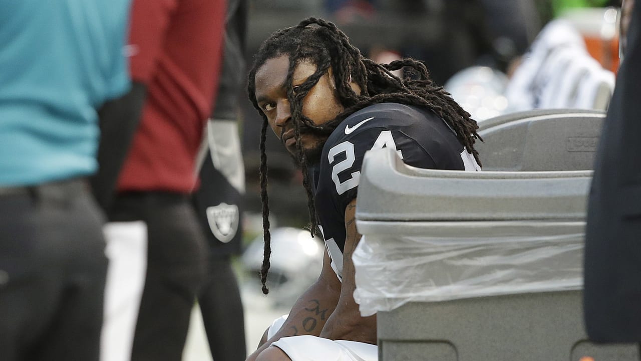 Raiders' Marshawn Lynch sits during national anthem before preseason game