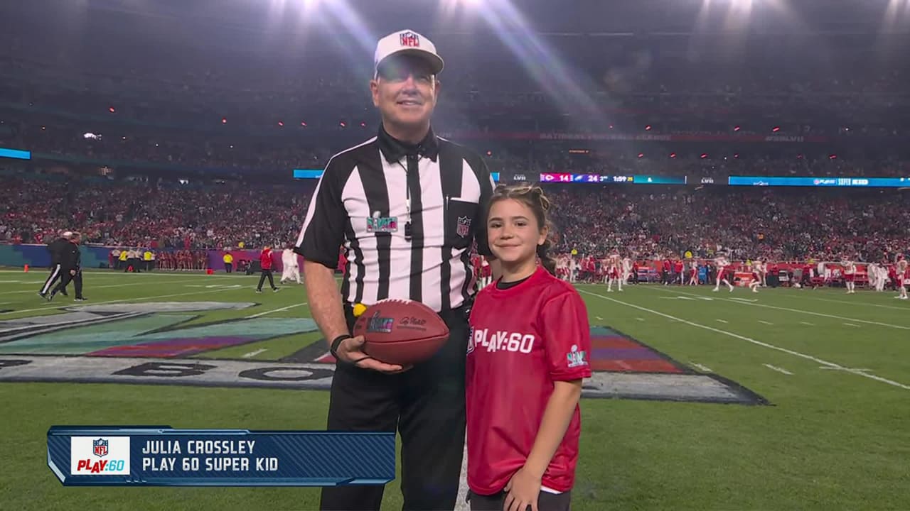 Julia Crossley delivers game ball to referee Carl Cheffers as part of NFL  PLAY 60