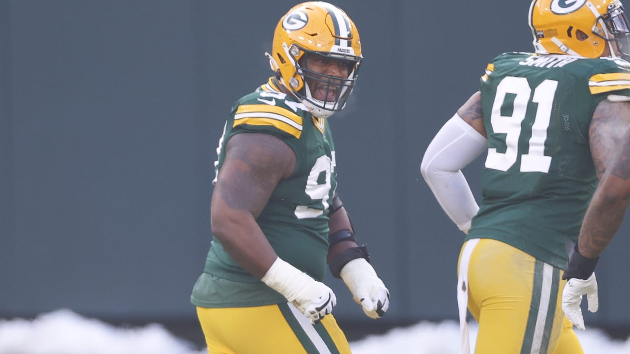 Green Bay Packers nose tackle Kenny Clark, left, exchanges jerseys