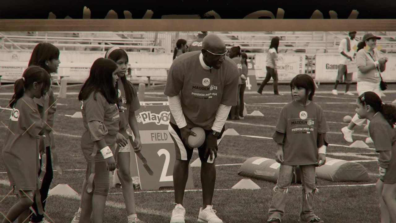 Former Atlanta Falcons linebacker Buddy Curry, center, models a