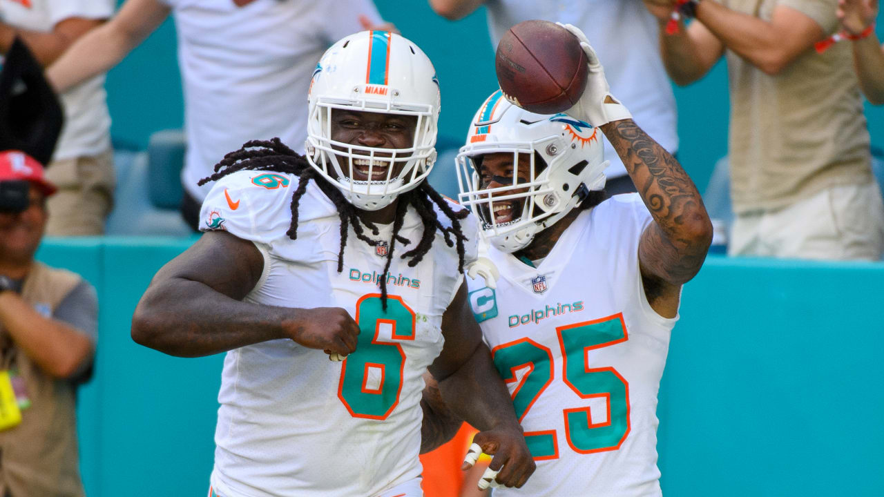 Miami Dolphins cornerback Xavien Howard (25) laughs as he celebrates  scoring a touchdown with Miami Dolphins cornerback Kader Kohou (28), Miami  Dolphins defensive tackle Raekwon Davis (98) and Miami Dolphins linebacker  Melvin