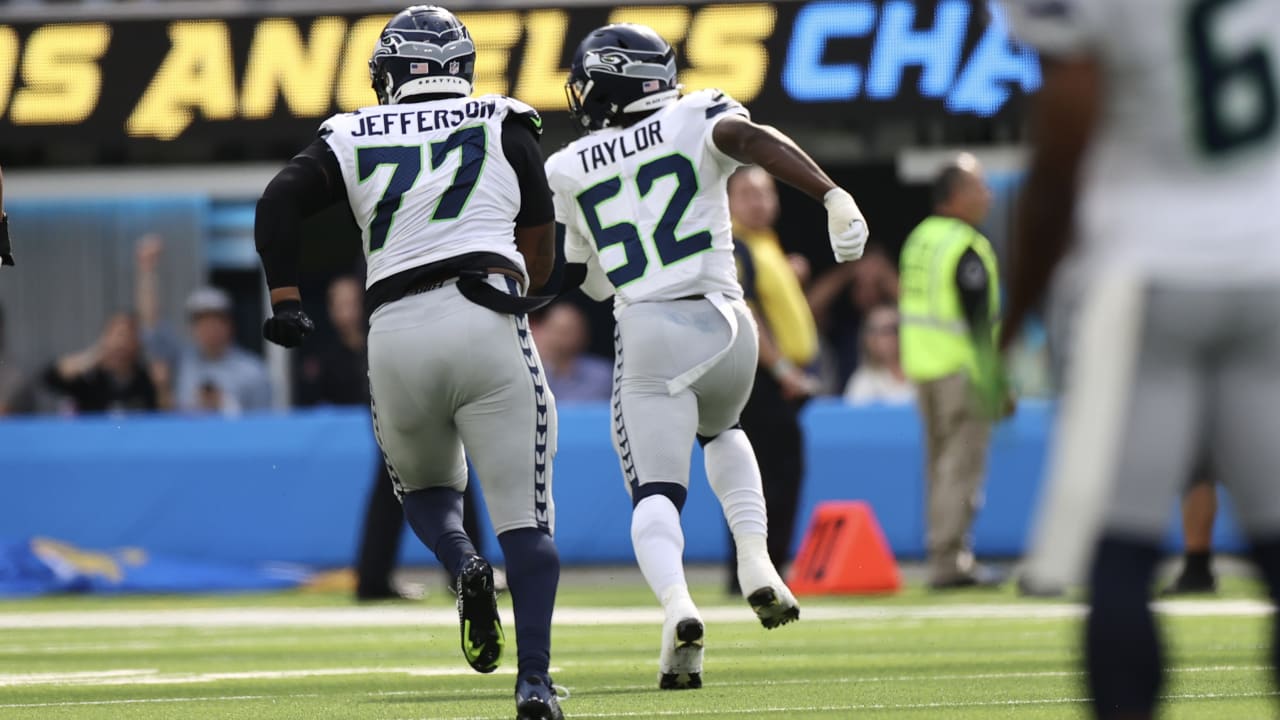 Darrell Taylor of the Seattle Seahawks attempts to block a pass by