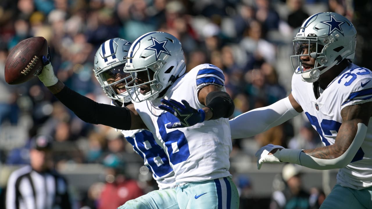 Dallas Cowboys safety Donovan Wilson scoops up running back Travis