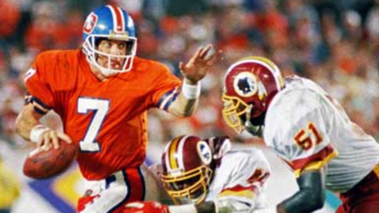 Washington Redskins cornerback Barry Wilburn (45) tries to stop Denver  Broncos Ricky Nattiel (84) from getting into the endzone after Nattiel  hauled in pass from quarterback John Elway during first quarter of