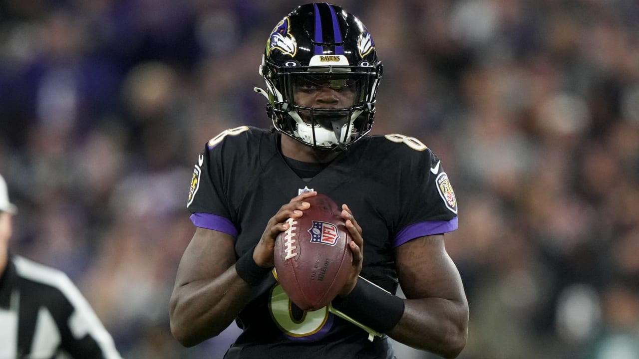 Baltimore Ravens quarterback Lamar Jackson (8) takes to the field with a  member of the military as part of Salute to Service before an NFL football  game against the Carolina Panthers, Sunday