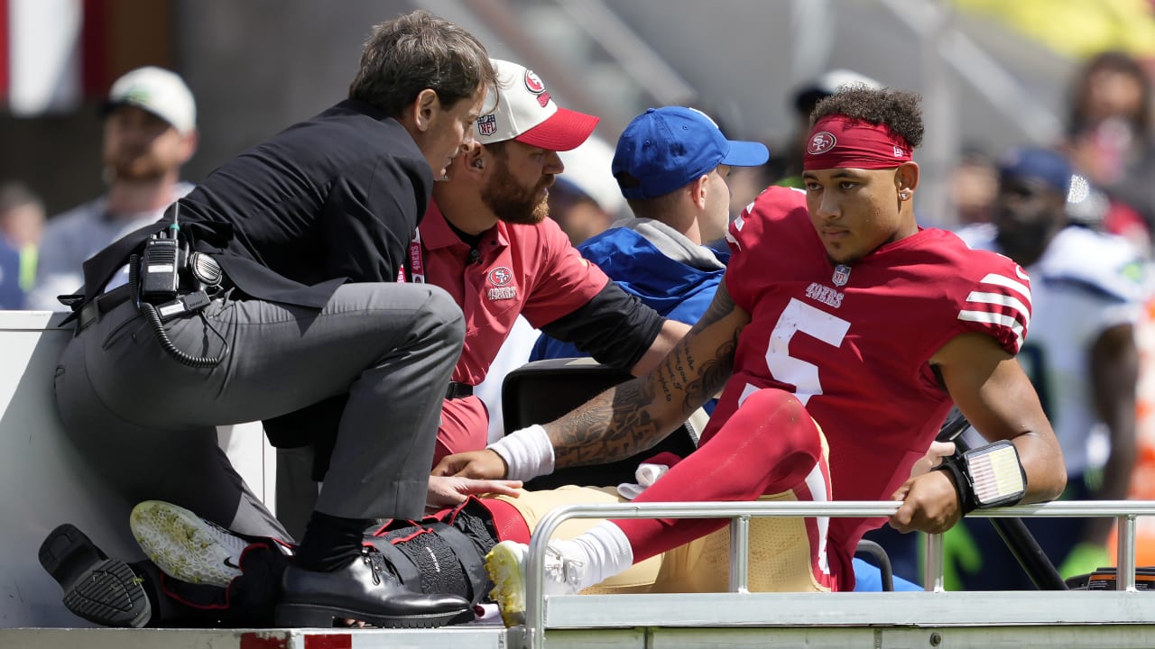 Injured San Francisco 49ers quarterback Trey Lance, facing hugs