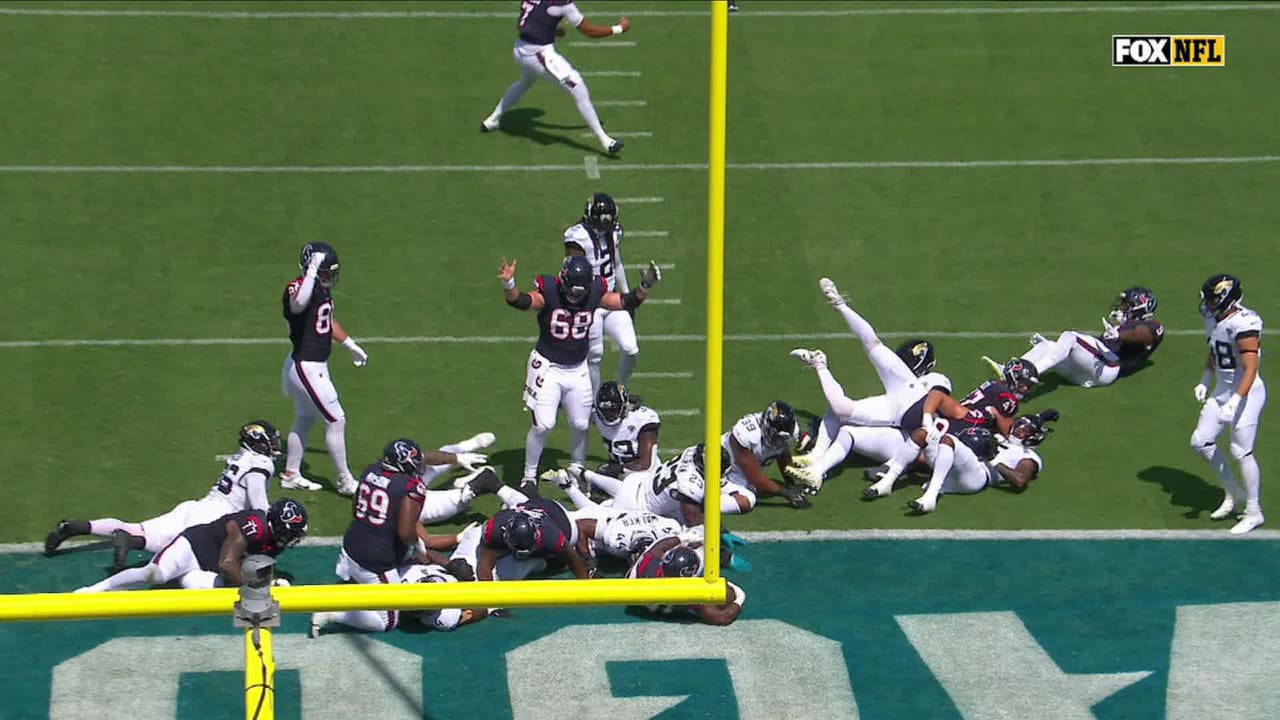 Houston Texans guard Shaq Mason (69) spikes the ball as he celebrates a  touchdown by teammate Dameon Pierce (31) during the first half of an NFL  football game against the Jacksonville Jaguars