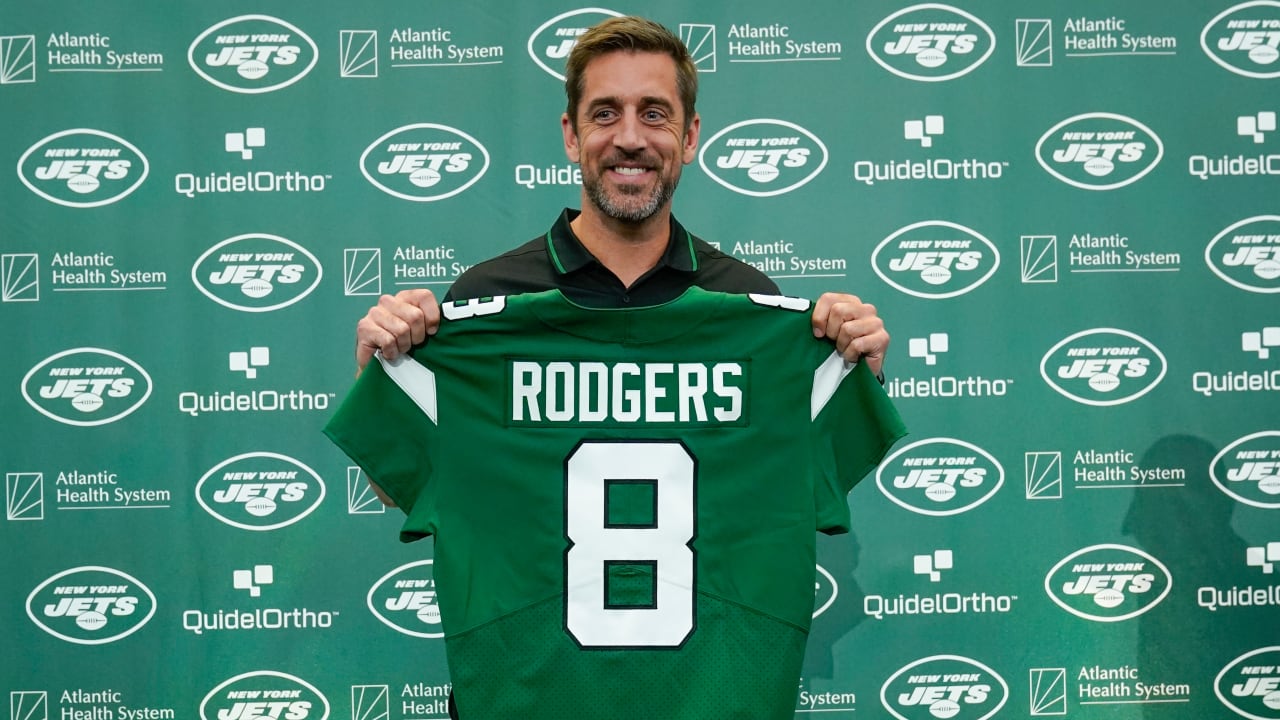 First look: New York Jets quarterback Aaron Rodgers holding up his No. 8  Jets jersey for photos