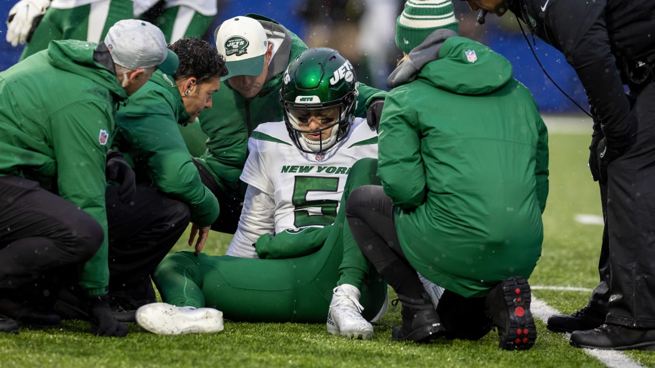 New York Jets quarterback Mike White (5) tries to avoid being taken down by  Buffalo Bills' Matt Milano, bottom, during the second half of an NFL  football game, Sunday, Nov. 14, 2021