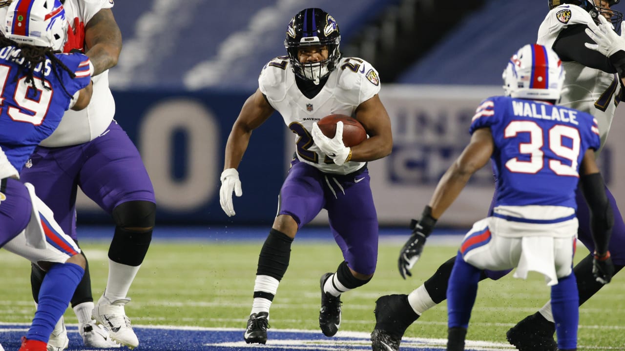 Baltimore Ravens quarterback Lamar Jackson eludes the rush to hit