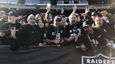 Oakland Raiders fans cheer during an NFL game against the Los